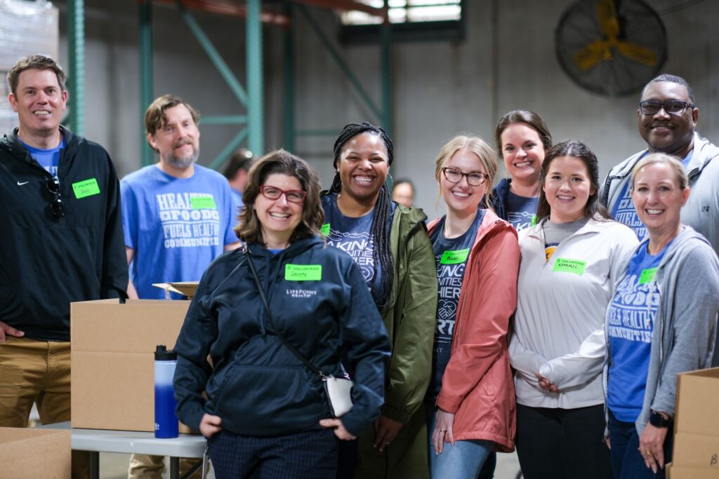 Lifepoint staff pose for photo at Second Harvest food packing event.