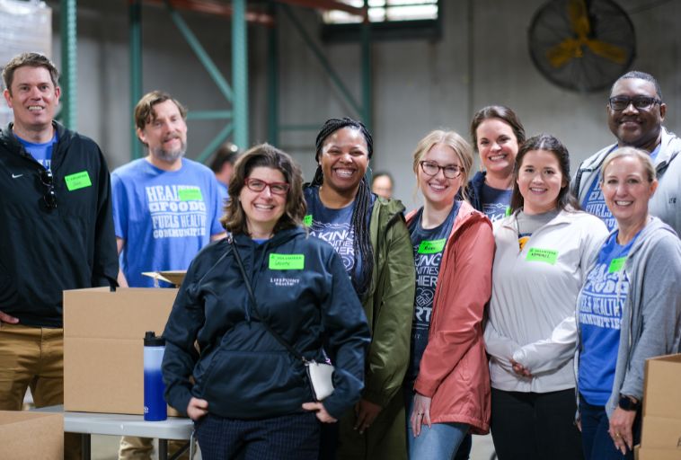 Lifepoint staff pose for photo at Second Harvest food packing event.